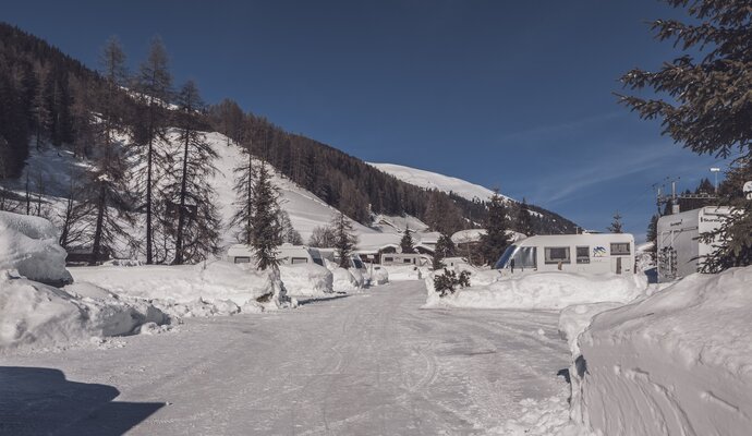 Beschneiter Stellplatz am Fluss beim Rinerhorn. | © Davos Klosters Mountains